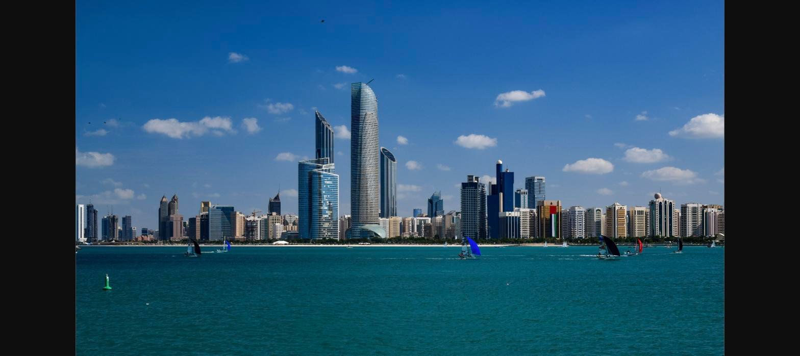 Abu Dhabi skyline viewed from the Corniche, showing Etihad Towers and downtown high-rises along the waterfront