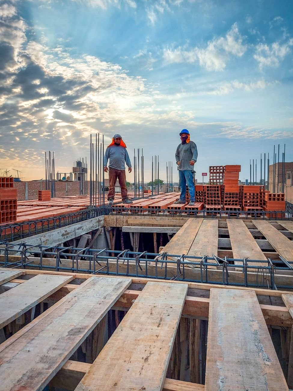 Two construction workers on an elevated deck, illustrating the US construction labor shortage