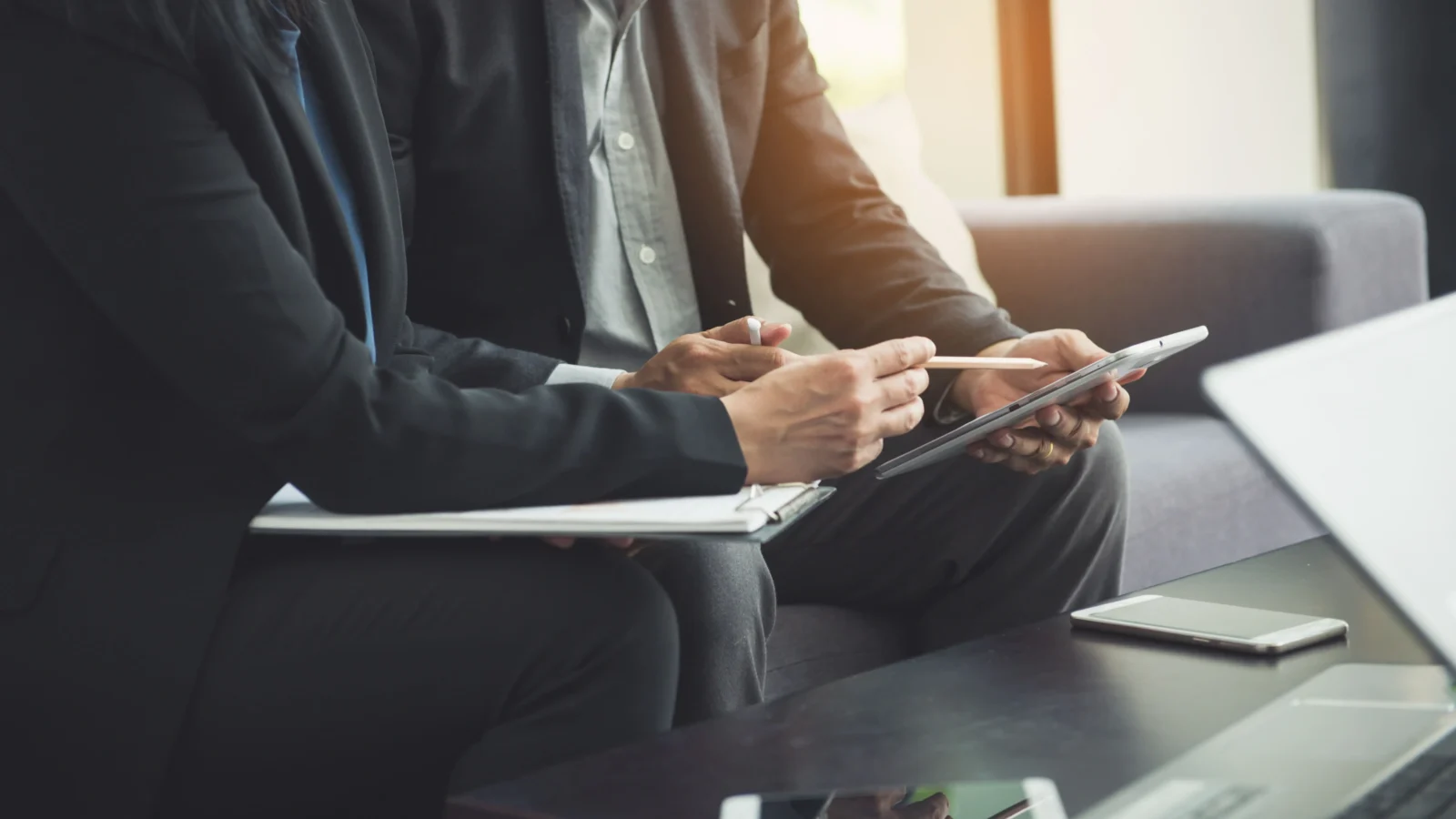 Advisors reviewing a tablet